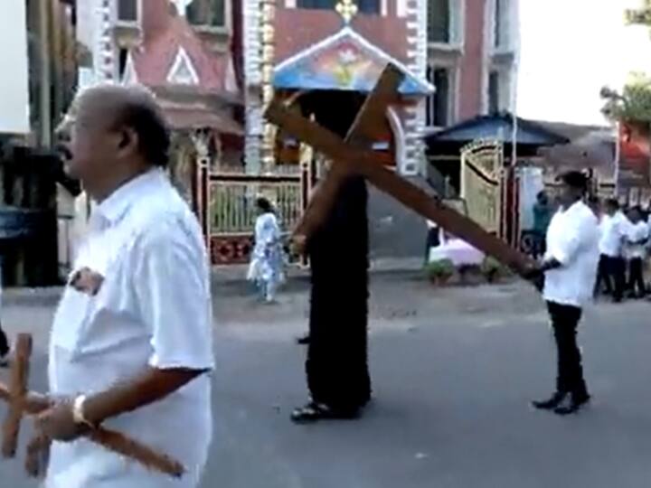 A parishioner carries carries a wooden cross depicting the crucifixion of Jesus Christ during a procession on the occasion of Good Friday in Thiruvananthapuram, Kerala.
