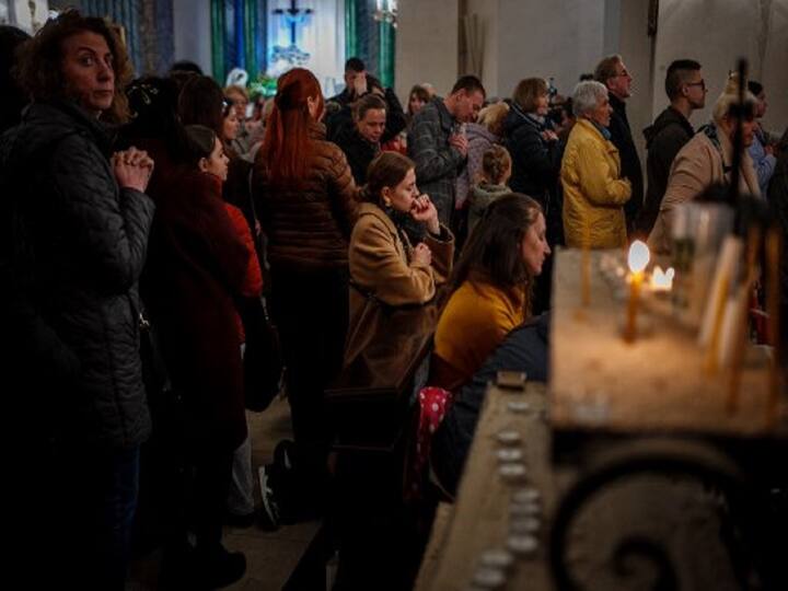 In the midst of Russia's invasion of Ukraine, believers attend the Easter Vigil mass at the Roman Catholic Parish of Saint Alexanders in Kyiv. (Image Source: AFP)