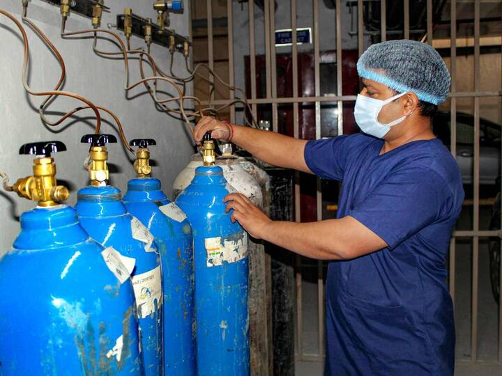 Healthcare workers were seen checking oxygen cylinders during a mock drill in Dehradun. (Source: PTI)