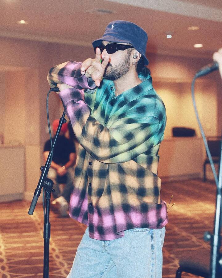 Diljit was dressed in a multicoloured check shirt and blue denims