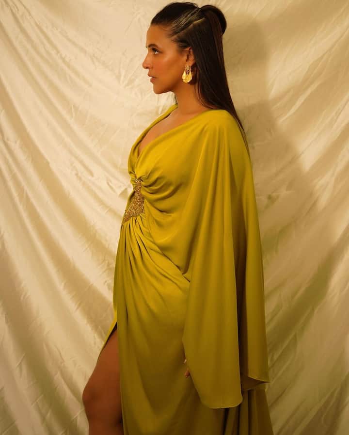 Neha dhupia was seen in this olive green outfit with a deep plunging neckline and a slit on one side. (Image Source: Instagram/Neha Dhupia)