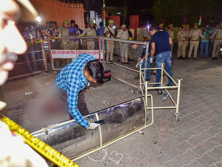 Forensic team at the spot where Gangster-turned-politician Atiq Ahmed and his brother Ashraf Ahmed were shot dead while they were being taken for a medical checkup, in Prayagraj, Saturday, April 15, 2023.