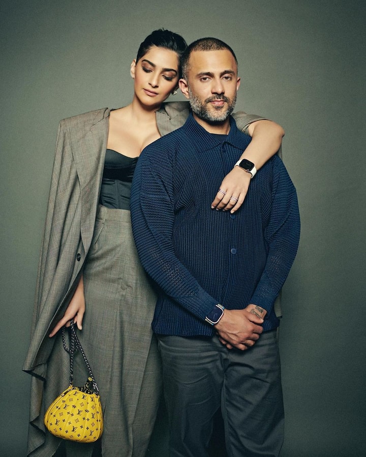 Sonam dressed up in a formal outfit wearing a black top that she paired with a knee-length grey skirt, while Anand wore a navy blue shirt with dark grey pants. (Image Source: Instagram/Sonam Kapoor)