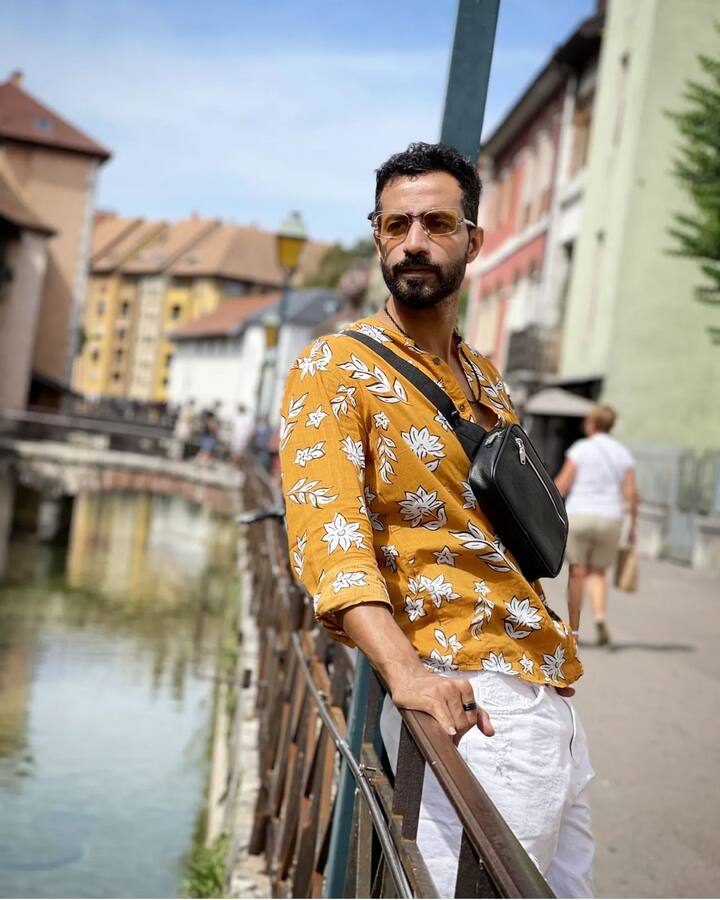 Dressed in rugged white shorts with a floral shirt, Bhuvan completed his look with sneakers and a crossbody bag.