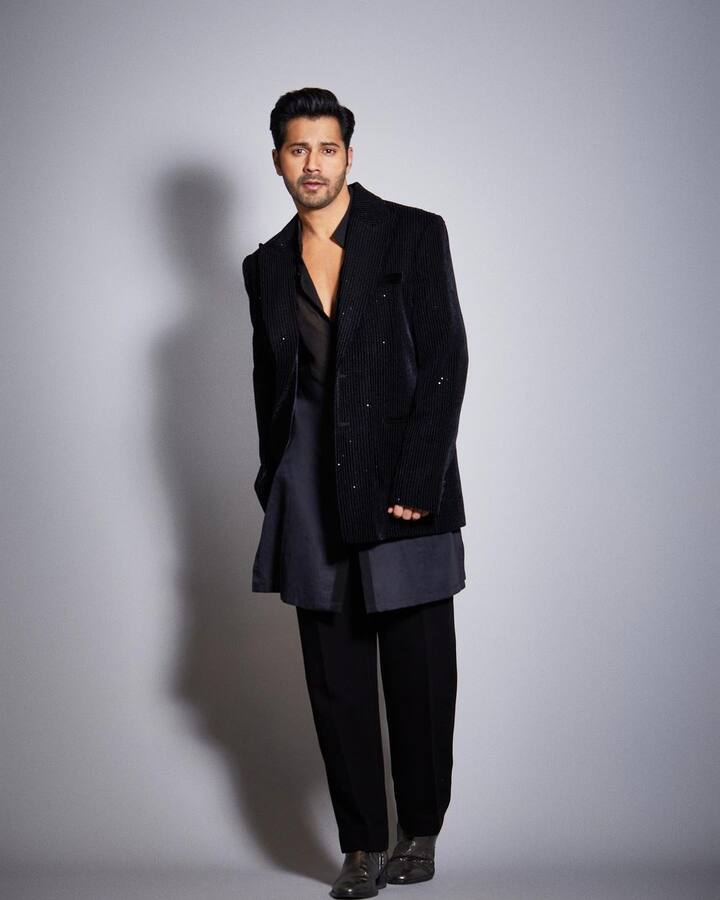 In a sharp indo-western black suit, Varun Dhawan casually tosses off a thirst trap.