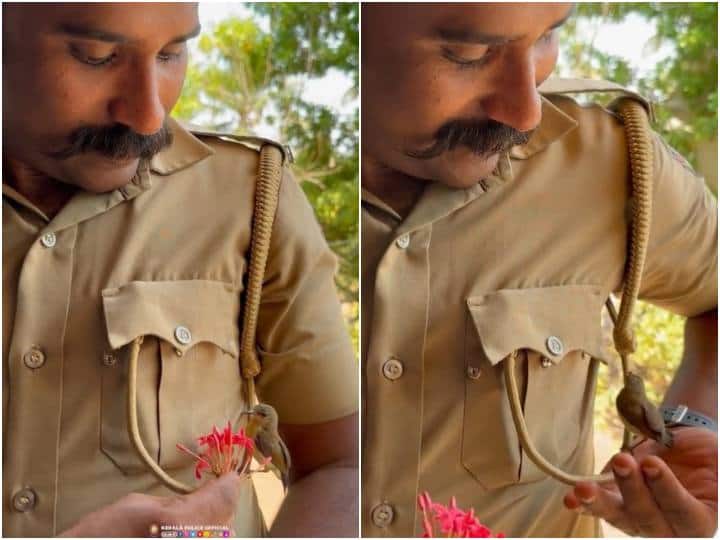 A bird was seen sitting on uniform of a Kerala Police officer Video: अचानक वर्दी पर आकर बैठ गई चिड़िया, पुलिसकर्मी ने किया दिल जीत लेने वाला काम