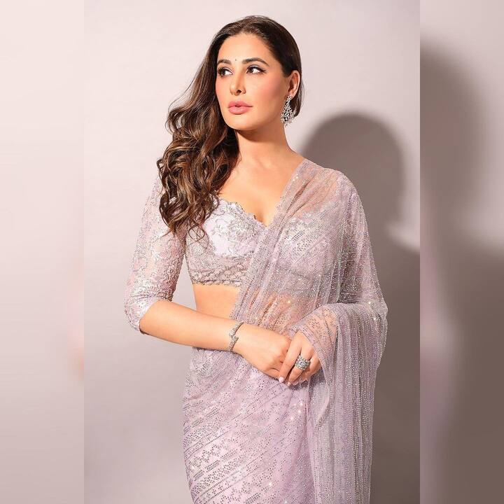 She paired the outfit with a matching blouse that had a deep neckline with three-quarter sleeves. (Image Source: Instagram/Nargis Fakhri)