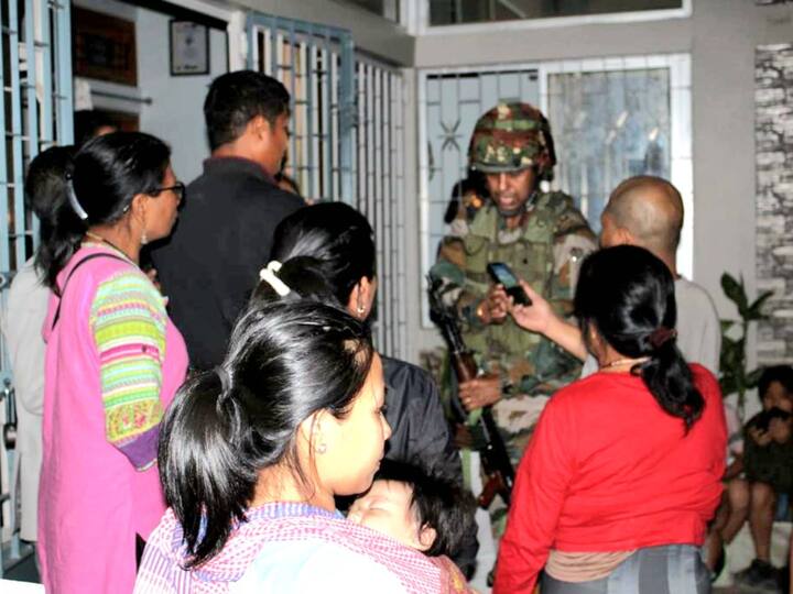 Army personnel giving information to a family about the shelters, after violence erupted in Manipur.