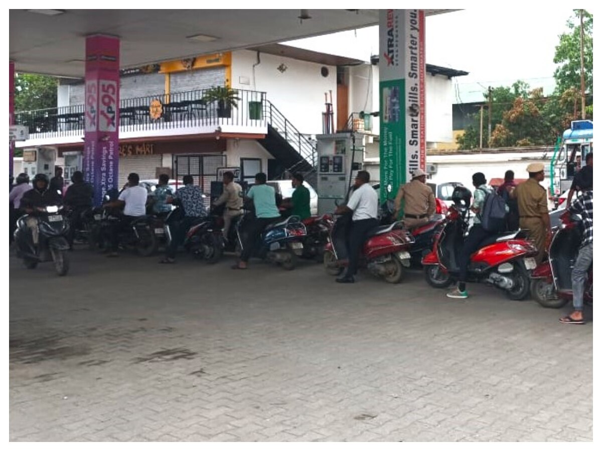 Long queues of two-wheelers at petrol depot.
