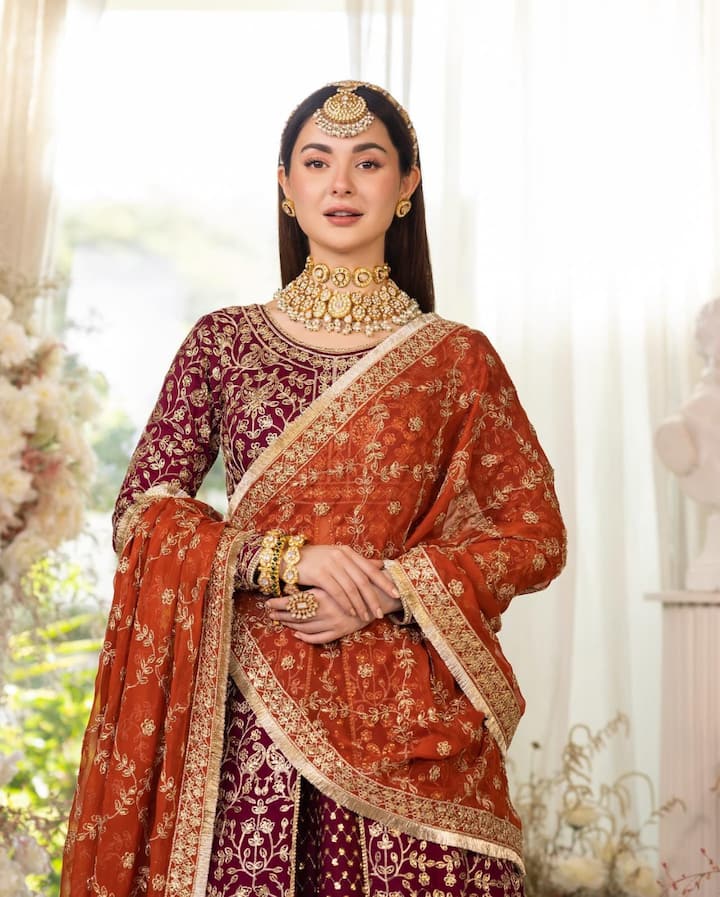 पर्पल और आरेंज कलर के कॉम्बिनेशन वाले इस ड्रेस में हानिया एकदम परी लग रही हैं.निकाह पर आप भी इस तरह से कॉन्ट्रास्ट करके आउटफिट कैरी कर सकती हैं.हानिया ने माथापट्टी और हेवी नेकलेस से अपने लुक को कंप्लीट किया है.