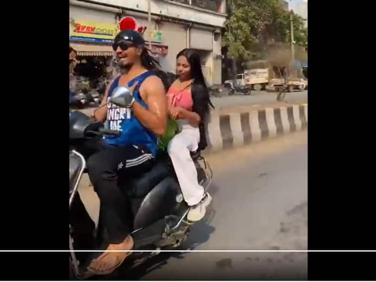 Maharashtra: Video Of Couple 'Bathing' While Riding Scooty Goes Viral. WATCH Maharashtra: Video Of Couple 'Bathing' While Riding Scooty Goes Viral. WATCH