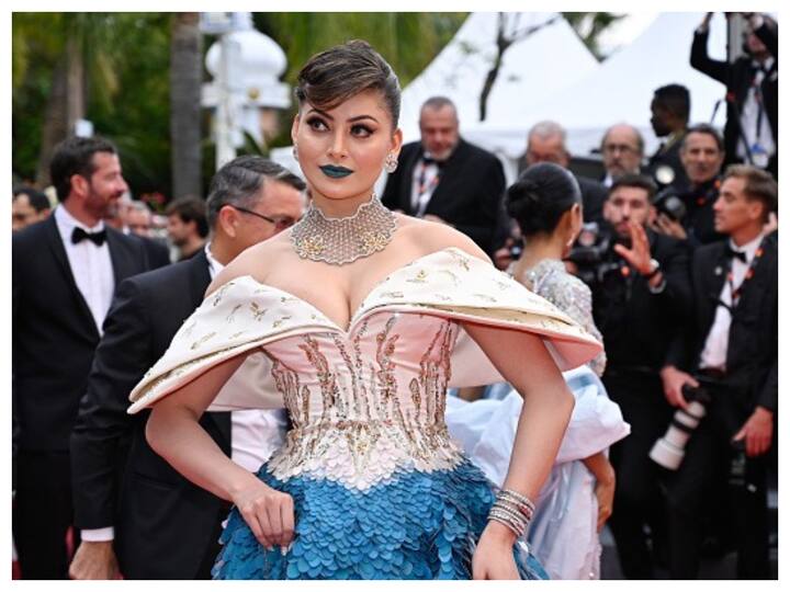 Urvashi Rautela attended the screening of 'Indiana Jones and the Dial of Destiny' at the Cannes Film Festival wearing a cream and blue gown.