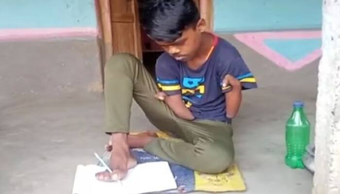 Passed the exam by writing with feet, not hands, Divyang tribal student Jagannath presented an example.