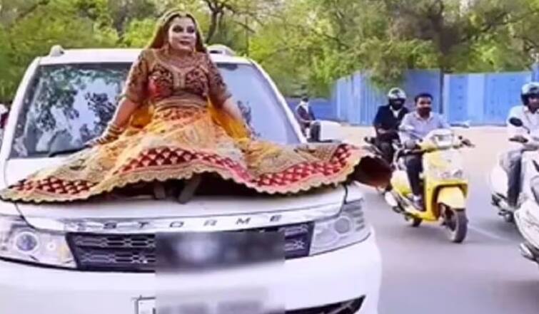 UP: Woman in bridal dress poses on bonnet of moving car for making reels Viral Video : દુલ્હને ચાલતી કારના બોનેટ પર બેસીને બનાવી રીલ, વીડિયો વાયરલ થતા પોલીસે  ફટકાર્યો આટલા હજારનો દંડ