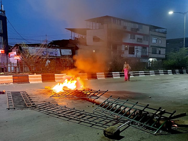 Tyres being burnt and construction materials piled up in the middle of the road by protestors during a protest, in Imphal, Monday. At least five people, including a policeman, were killed and 12 others injured after fresh violence erupted in Manipur on Sunday. (Image Source: PTI)