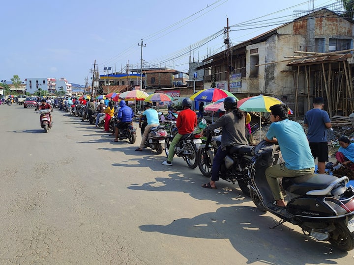 Visual of people waiting in queue to buy petrol at a fuel station, in Imphal as several petrol pumps were shut down due to the blockade on national highways. (Image Source: PTI)