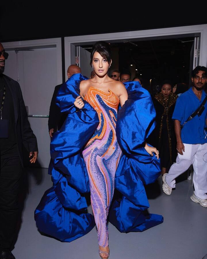 She wore an orange and blue beaded gown by Jean Pierre Khoury.