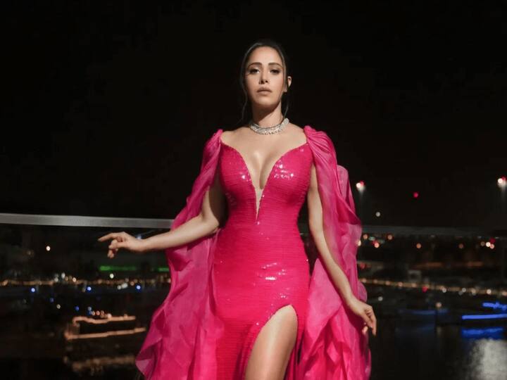 In her most recent post, Nushrratt Bharuccha charms in a stunning pink gown with a thigh-high split.