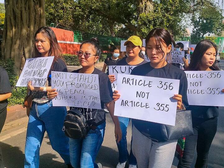 Kuki community people display placards during a protest outside Union Home Minister Amit Shah's residence against the ongoing violence in Manipur. Image Source: PTI