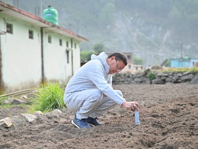 Uttarakhand CM Pushkar Singh Dhami Visit To Uttarkashi Seen Sowing Ragi In  Siror Village See Photos  Uttarakhand News              