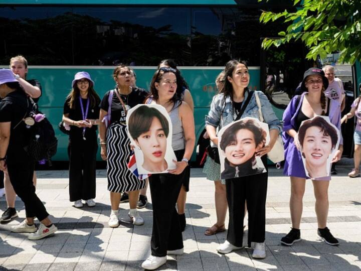 Members of the Australian chapter of K-pop megastars BTS's global following, known as ARMY, carry cardboard cutouts of the group during their 12-day 