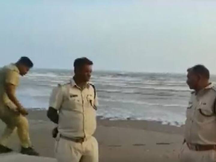 Police deployed near the coast in Gujarat's Navsari to prevent people from venturing into the sea. (Twitter/ANI)