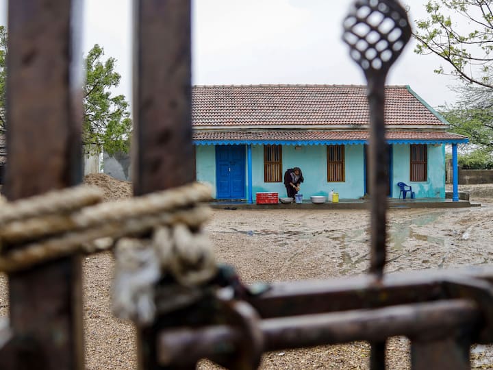 An entrance gate of a home tightened with rope in view of strong winds that will be caused by the cyclone as it makes landfall. (Image Source: PTI)