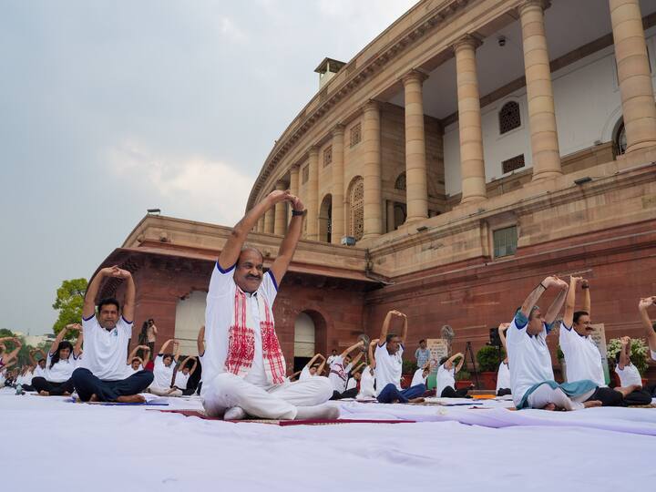 Lok Sabha Speaker Om Birla and others perform yoga on the International Yoga Day outside Parliament House in New Delhi.