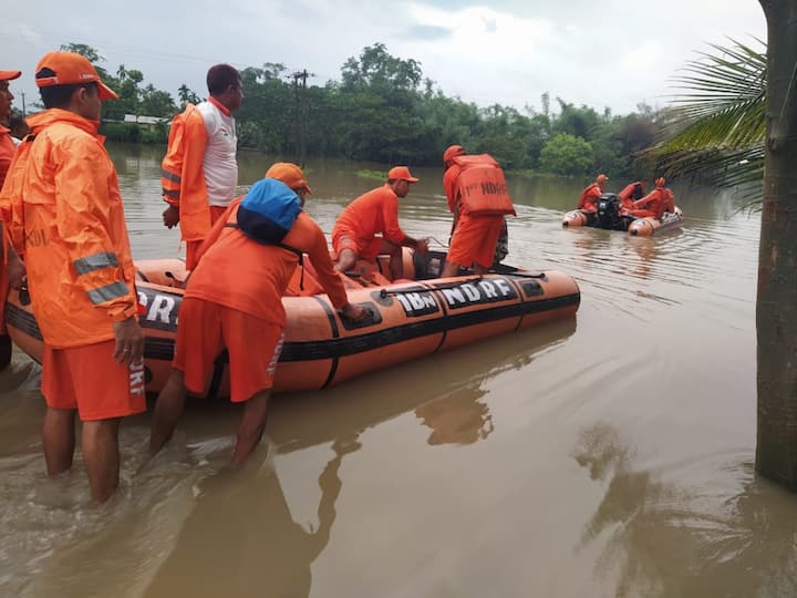 NDRF personnel push a rescue boat out into floodwaters in Tamulpur. (Image Source: Twitter/@ANI)