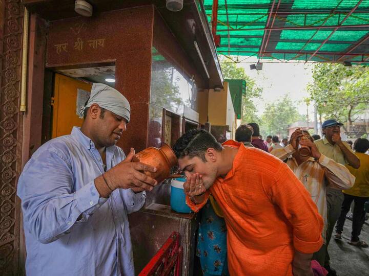 Delhi BJP supporters drink water during a protest against the AAP government over the issue of alleged shortage of water, in New Delhi, Saturday, June 24, 2023. (PTI Photo/Arun Sharma)