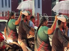 Elderly Woman Protects Son From Rain While Getting Drenched Herself, Leaves Internet Emotional