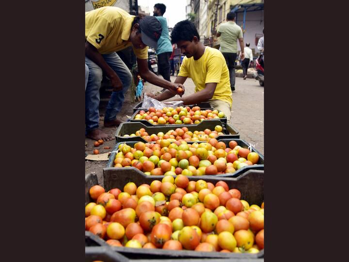 Vendors selling tomatoes at a market in Guwahati. A top government official said the spike in prices of tomatoes is a temporary seasonal phenomenon and rates will cool down soon. (Image Source: PTI)