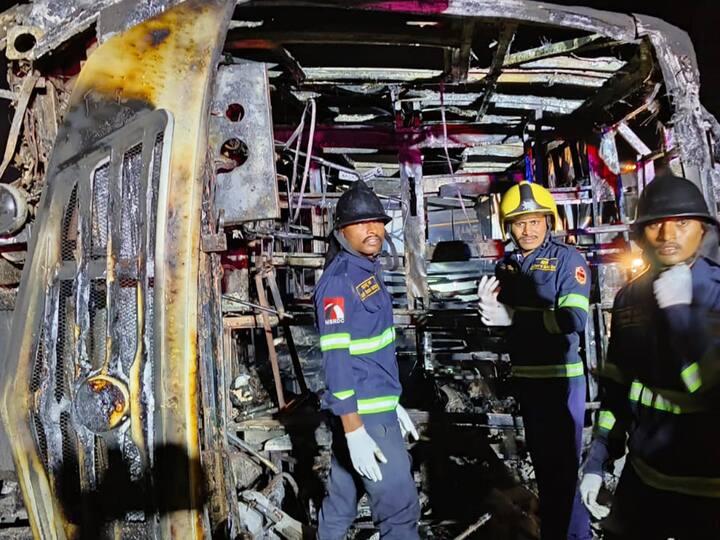 Rescue workers near the passenger bus which met with an accident and caught fire killing 25 passengers on the Samruddhi Expressway. (Source: PTI)