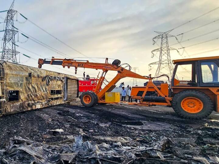 Relief work continues, a bulldozer is in use to remove the bus from the highway. Experts would be consulted before putting in place measures to prevent accidents, CM Shinde said. (Source: PTI)