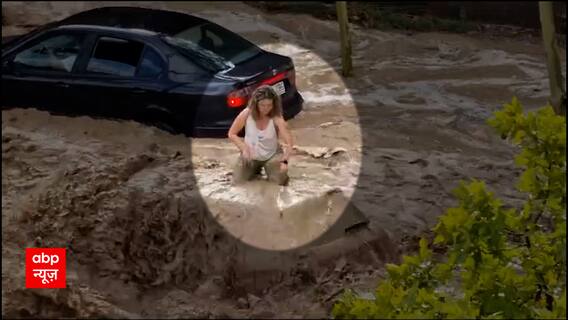 Woman takes refugee on Car roof amid heavy flooding in Zaragoza, Spain