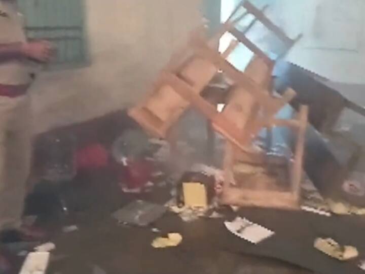 Image of a destroyed polling booth while a police officer takes stock of the situation. (Image Source: Twitter/@ANI)