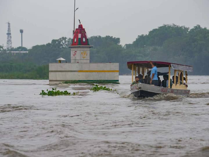 Meanwhile, some people were also seen taking a ride on a boat in the Yamuna river after heavy monsoon rains. (Source: PTI)