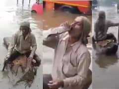 భారీ వరదల్లోనూ భలే ప్రయాణం - దుంగపై కూర్చొని దర్జాగా  వెళ్తున్న వ్యక్తి