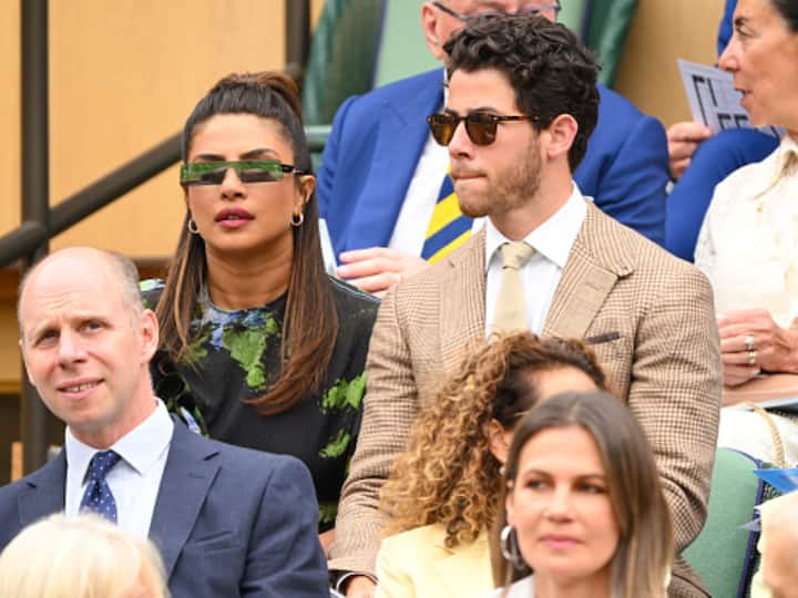 On the other hand, Nick looked handsome in a light brown striped suit that he paired with a white shirt and a matching tie. (Image Source: Getty)