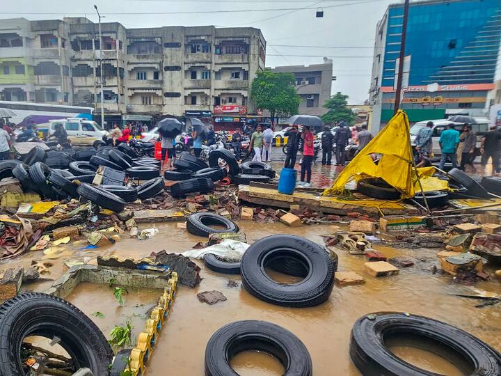 Tyres lay strewn on a road after a wall of the state transport bus workshop collapsed due to heavy rains, in Junagadh. (Image Source: PTI)