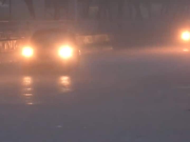 Vehicles on a road in Sector 20 of Noida during heavy showers. (Source: ANI)