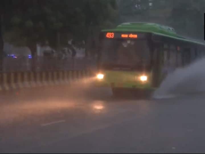 A bus wades through a waterlogged road near Sector 20 in Noida, early Wednesday morning amid rainfall. (Source: ANI)