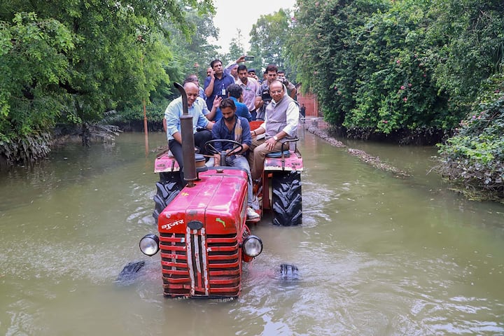 New Delhi: दिल्लीचे नायब राज्यपाल व्हीके सक्सेना यांना दिल्लीच्या पूरस्थितीची पाहणी करण्यासाठी ट्रॅक्टरची मदत घ्यावी लागली. हा परिसर राजघाटाचा आहे. तर तारीख आहे 18 जुलै 2023. राजधानी दिल्लीमध्ये जुलै महिन्यात किती मुसळधार पाऊस झाला आणि जनजीवन कसं विस्कळीत झालं असेल याचा अंदाज येण्यासाठी हा फोटो पुरेसा ठरावा (PTI Photo)