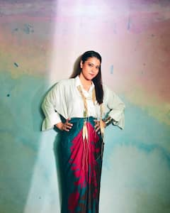 Kajol Poses In A White Shirt Paired With A Red And Blue Wrap Around Skirt
