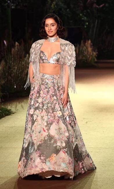 The lehenga was paired with a matching blouse and a short fringe cape over the blouse.