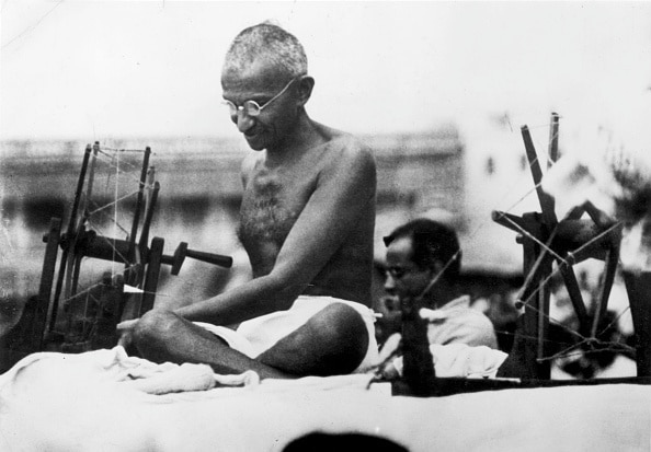 Gandhi Working On The Charkha (Image Source: Getty)