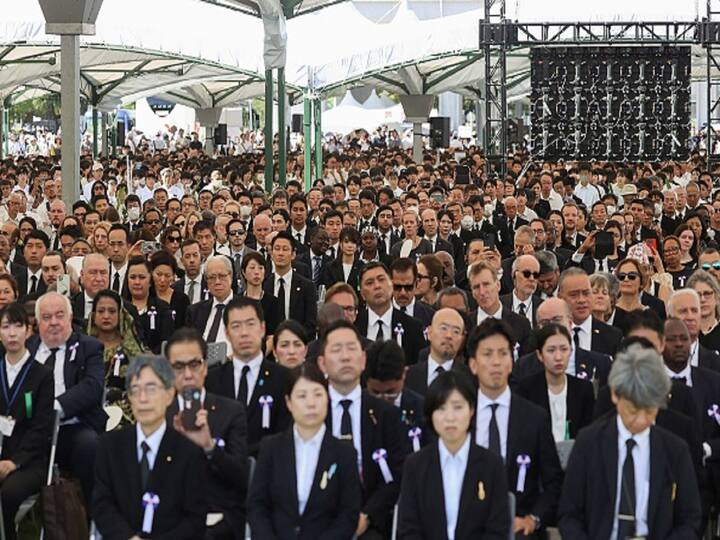 Gathering in Remembrance: Thousands gather for the memorial ceremony, including survivors, relatives, and representatives from 111 countries, joining hands in prayer for those lost and wounded, and calling for a world free of conflict. (Image Source: Getty)