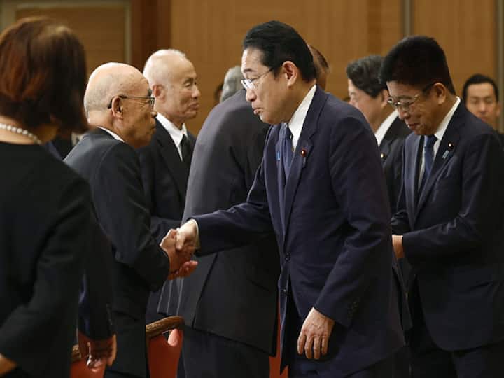 Tolling the Peace Bell: The peace bell rings at 8:15 am, mirroring the time the bomb fell, as 50,000 participants brave the sweltering heat to observe a moment of silence in the outdoor memorial ceremony. (Image Source: Getty)