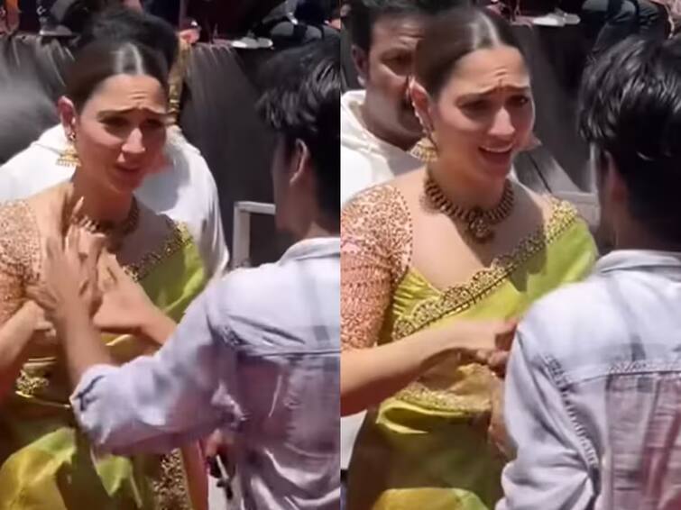 actress Tamannaah Bhatia Fan Breaks Security, Grabs Her Hand at Event Her Reaction Goes Viral; Watch News Marathi Tamanna Bhatia Fan Video : सिक्युरिटीला न जुमानता चाहता गर्दीतून आला आणि थेट तमन्ना भाटियाचा  हात पकडला; मग अभिनेत्रीनं जे केलं ते पाहाच!