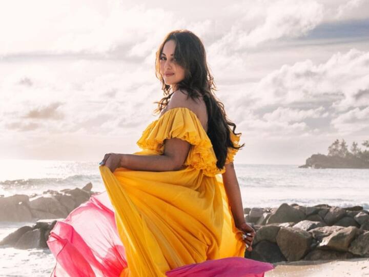 She was wearing a two-toned gown with a vivid fuchsia-pink border and a bright yellow bodice.